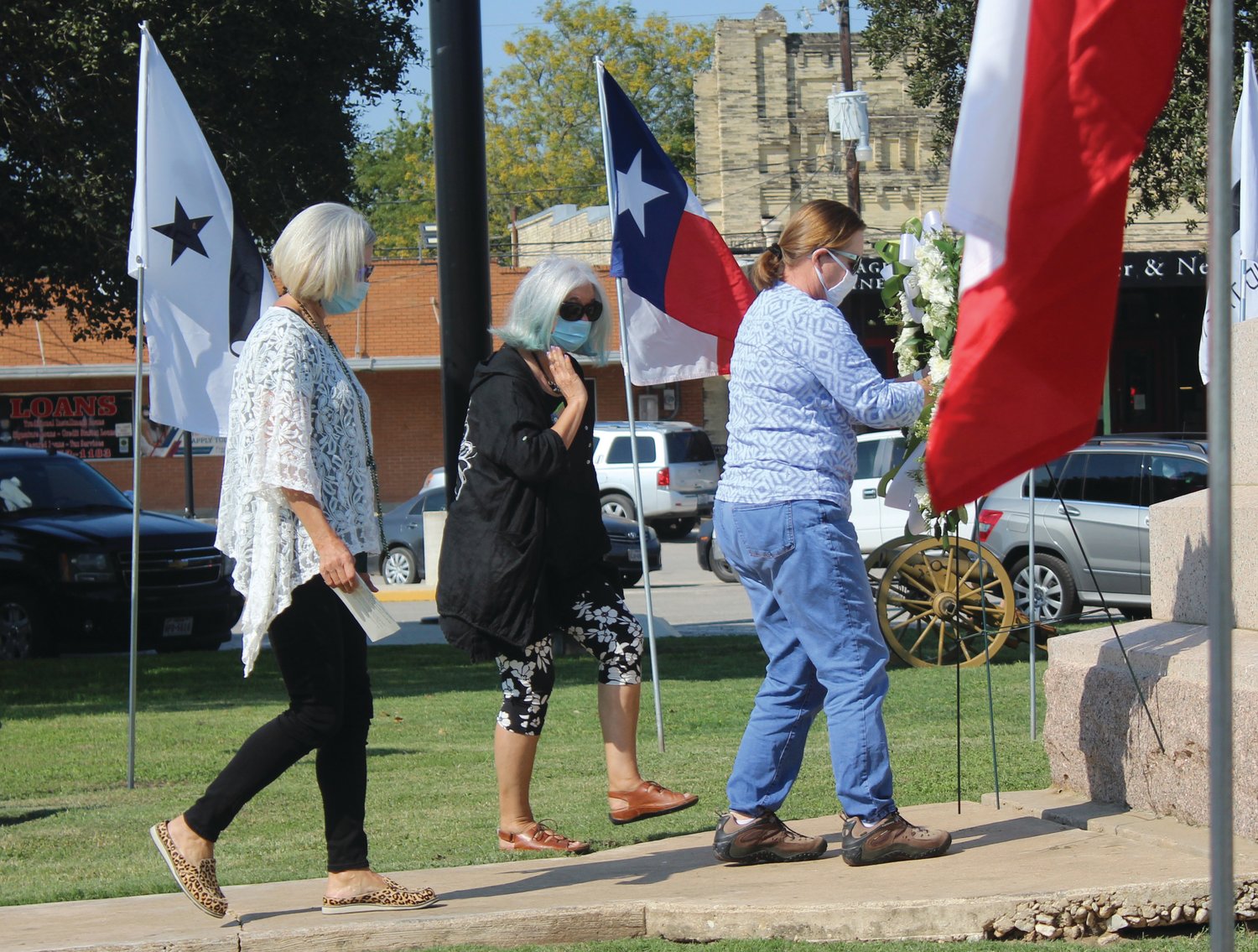 Members of the Daughters of the Republic of Texas placed a memorial wreath at the base of the monument in Texas Heroes square in October. The Gonzales Economic Development Corporation has hired a company to help repair the flags that fly in Texas Heroes Square.